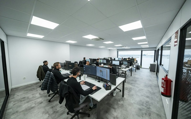 A modern software engineering office with a team working at their desks.